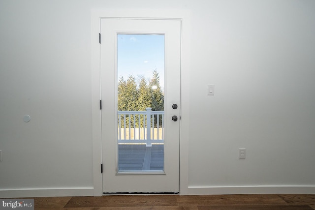 doorway with dark hardwood / wood-style flooring