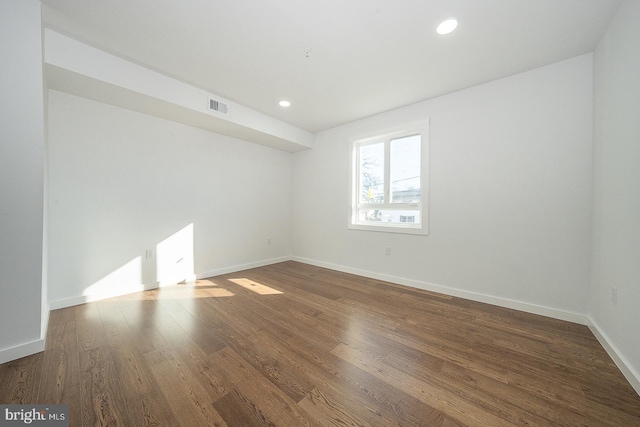 empty room featuring dark wood-type flooring