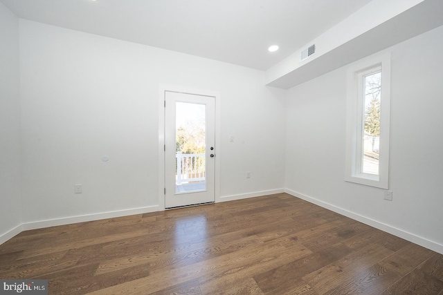 spare room with dark hardwood / wood-style floors