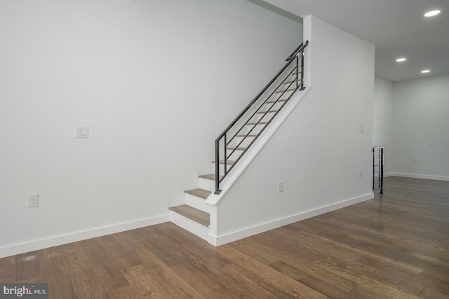 staircase with hardwood / wood-style floors