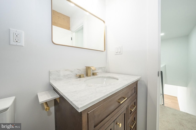 bathroom featuring vanity and toilet