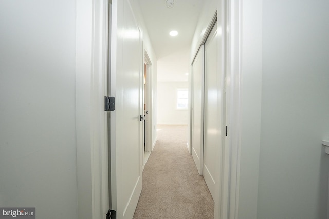 hall with light colored carpet