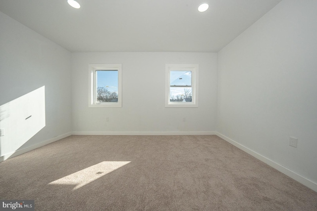 spare room featuring carpet flooring and plenty of natural light