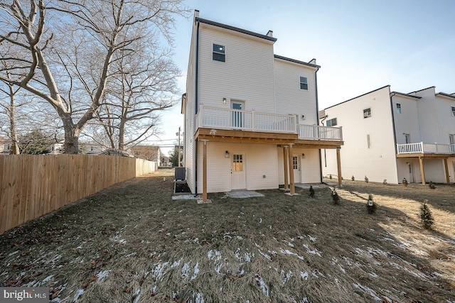 back of property with a deck and cooling unit