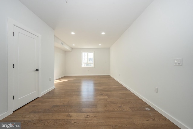 empty room with dark hardwood / wood-style flooring