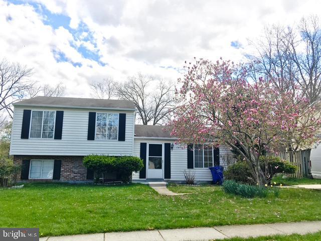 split level home featuring a front yard and a garage