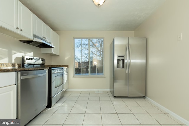 kitchen featuring stainless steel appliances, white cabinetry, and light tile patterned floors