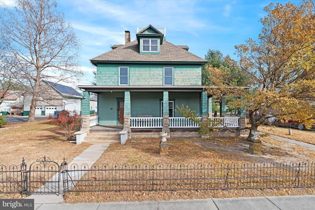 view of front of house with covered porch, a fenced front yard, and a chimney