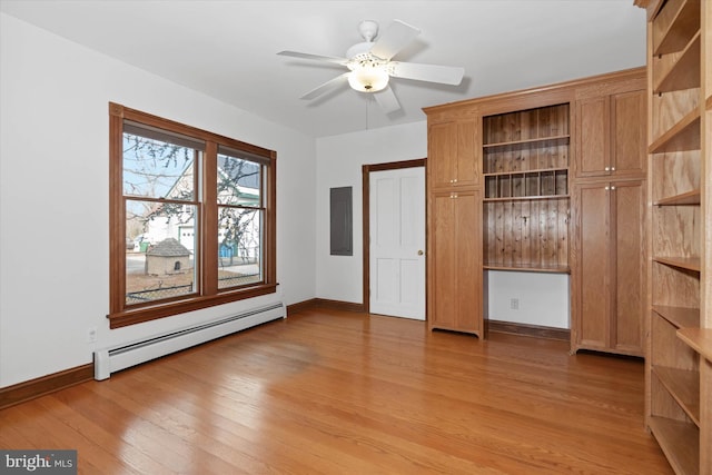 unfurnished bedroom with electric panel, ceiling fan, a baseboard radiator, and light hardwood / wood-style floors