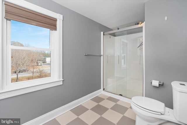 bathroom with an enclosed shower and toilet