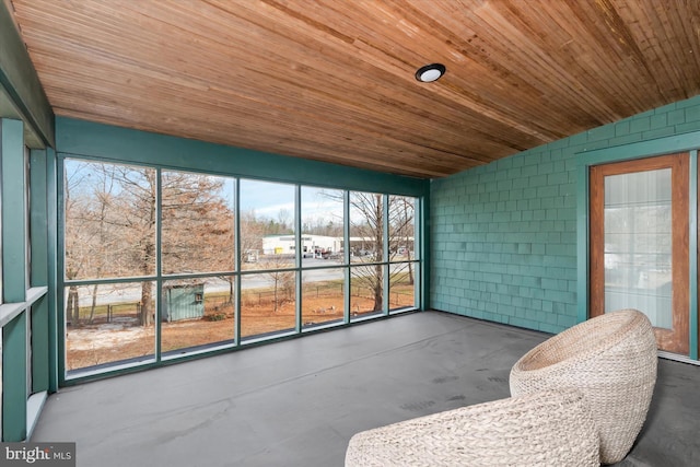 unfurnished sunroom with wood ceiling