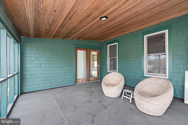 unfurnished sunroom featuring wood ceiling