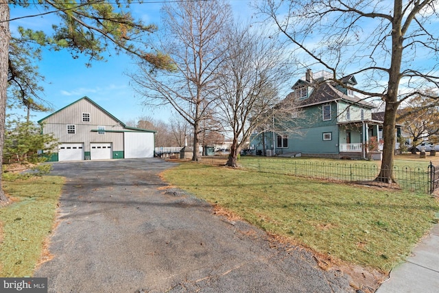 view of side of home featuring an outbuilding, a yard, and a garage