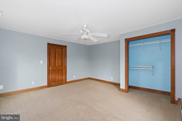 unfurnished bedroom featuring ceiling fan, a closet, and light carpet