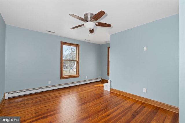 spare room with hardwood / wood-style floors, ceiling fan, and baseboard heating