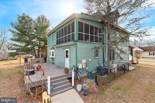 back of property featuring a sunroom, central AC unit, and a deck