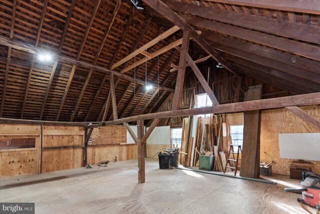 misc room with wooden walls and high vaulted ceiling