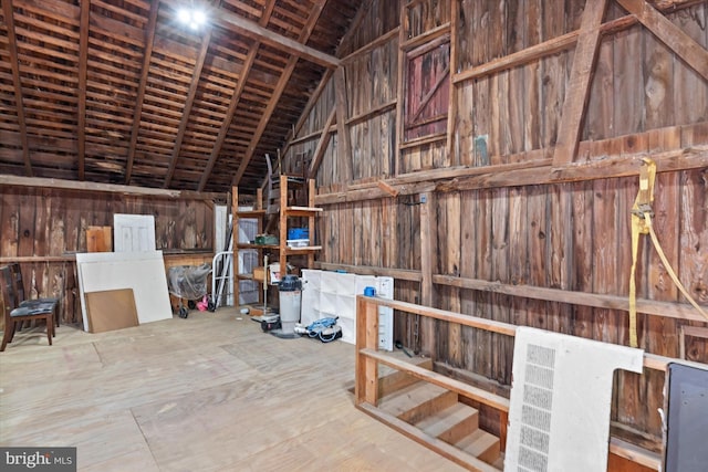 interior space featuring wood walls and lofted ceiling