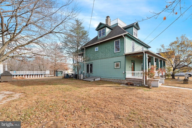 view of property exterior with a lawn and a porch