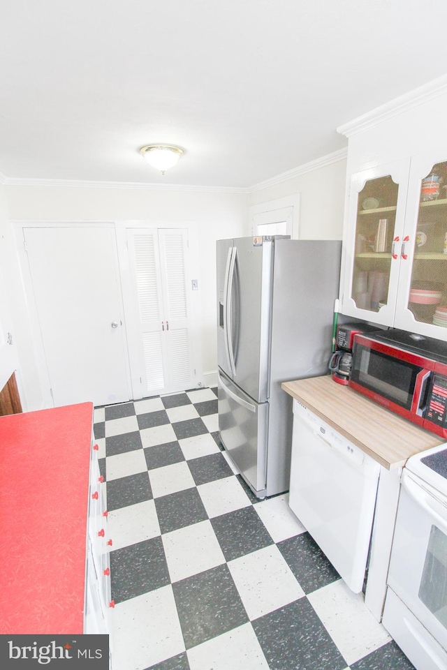 kitchen featuring white appliances, butcher block countertops, crown molding, and white cabinets