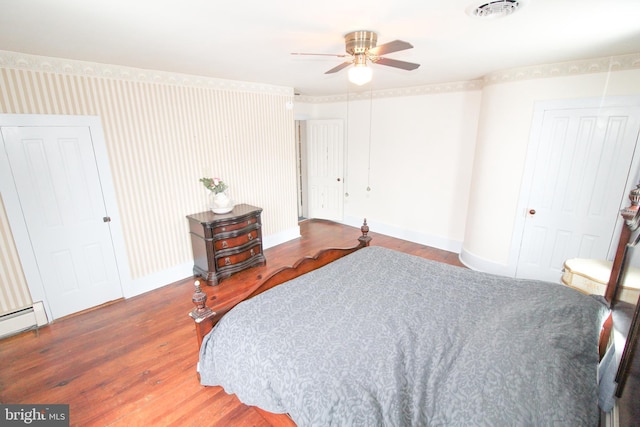 bedroom featuring ceiling fan, a baseboard radiator, and dark hardwood / wood-style floors