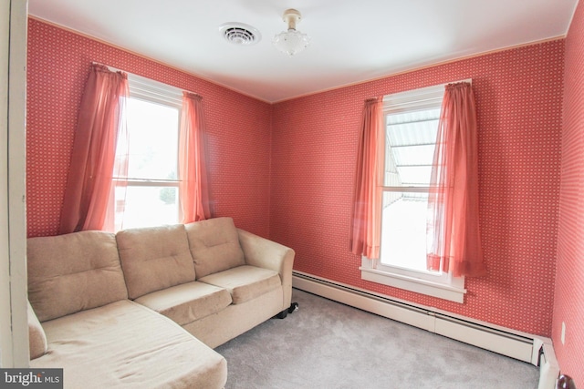 living area with a baseboard radiator and carpet