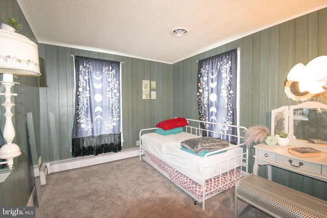 carpeted bedroom featuring a baseboard radiator, wood walls, and ornamental molding