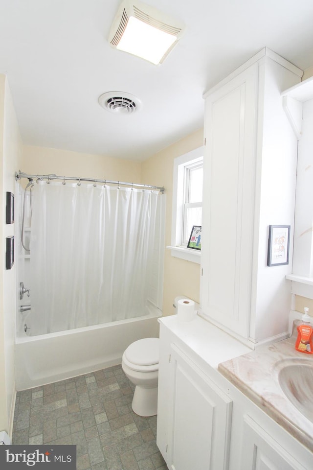 full bathroom with shower / tub combo, vanity, and toilet