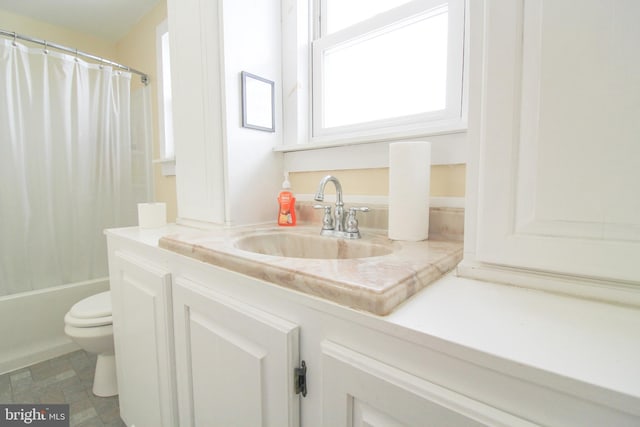 full bathroom with shower / bath combo, vanity, and toilet