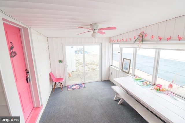 unfurnished sunroom with ceiling fan