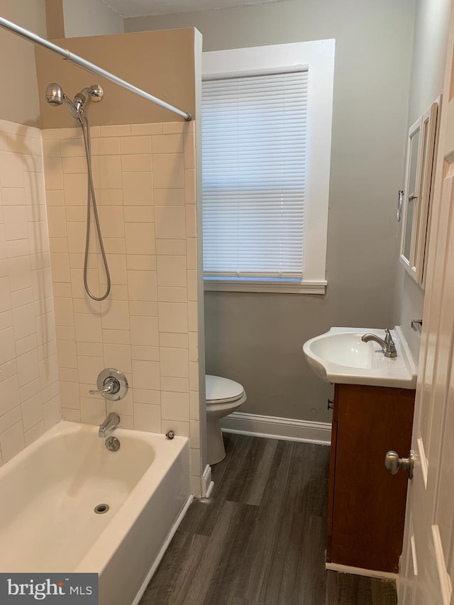 full bathroom featuring vanity, toilet, wood-type flooring, and tiled shower / bath