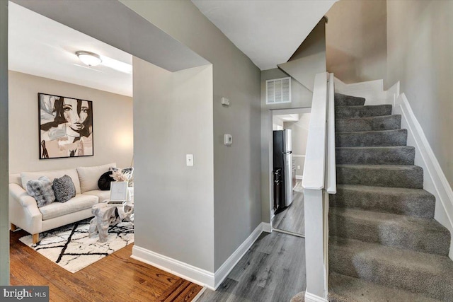 stairway featuring hardwood / wood-style flooring