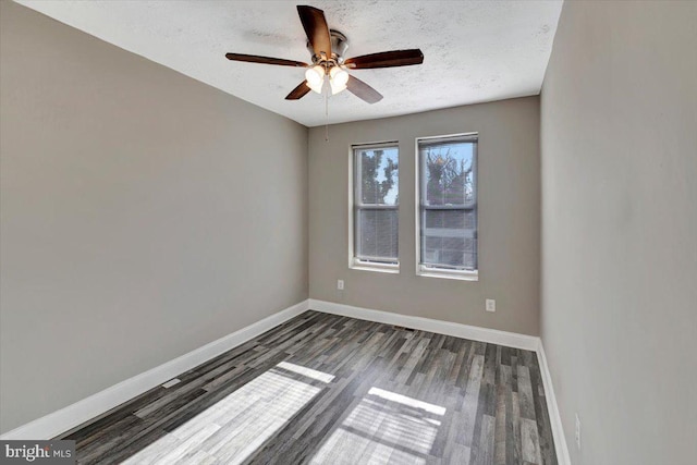 unfurnished room with a textured ceiling, dark hardwood / wood-style floors, and ceiling fan