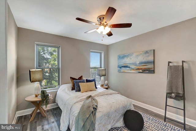 bedroom with ceiling fan and dark hardwood / wood-style floors