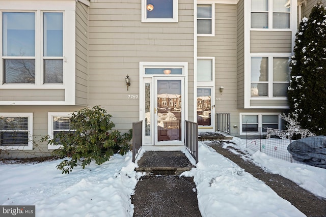 view of snow covered property entrance