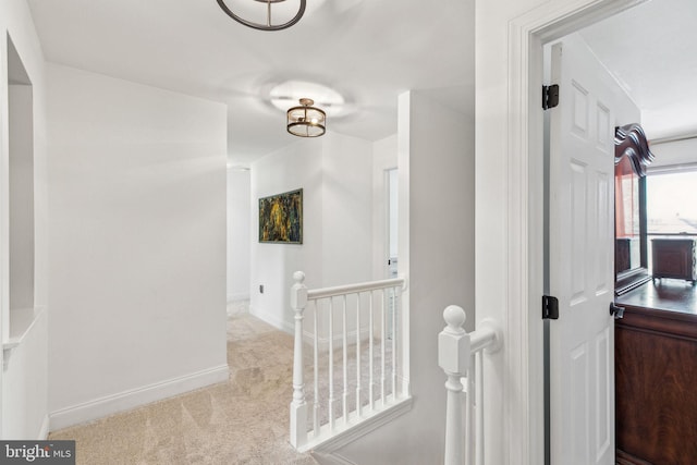 hall featuring light colored carpet