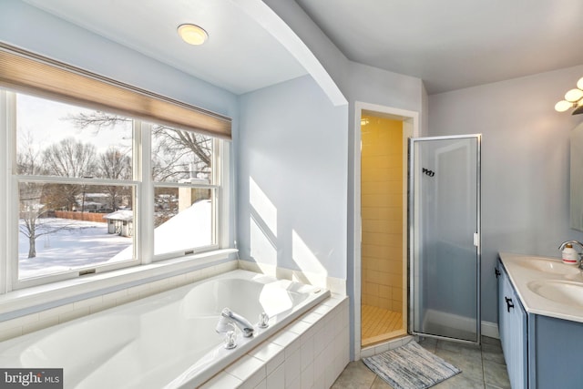 bathroom featuring vanity, tile patterned floors, and shower with separate bathtub