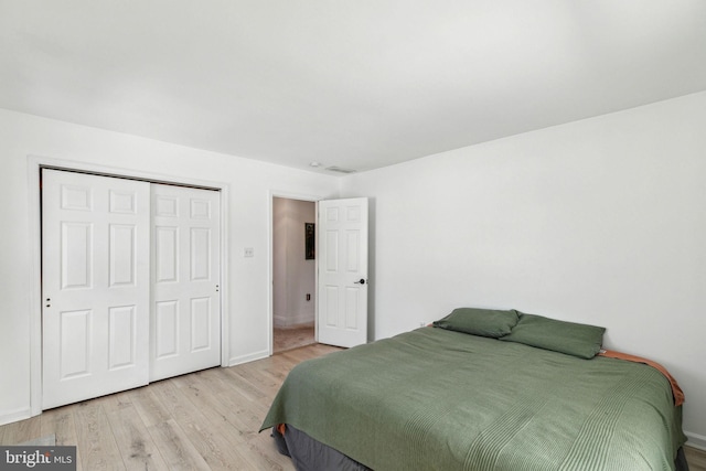 bedroom featuring a closet and light wood-type flooring