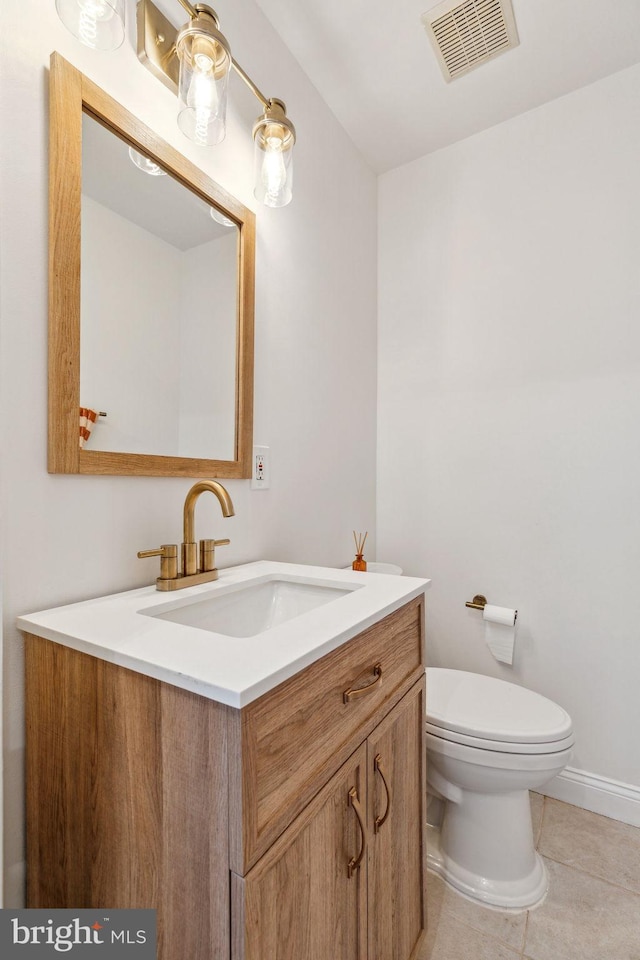 bathroom featuring vanity, toilet, and tile patterned floors