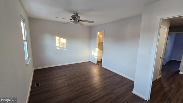 unfurnished room with dark hardwood / wood-style floors and ceiling fan