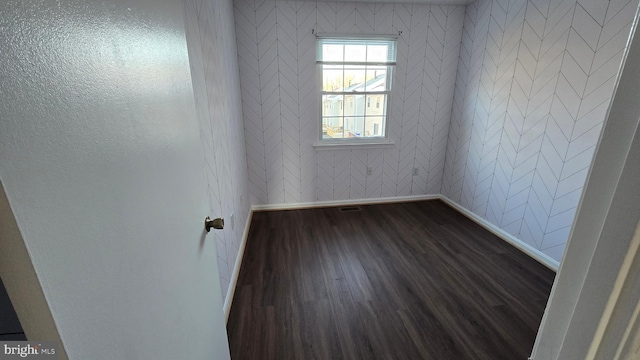 unfurnished room with dark hardwood / wood-style flooring