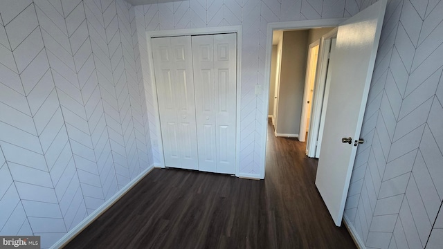 hallway with dark hardwood / wood-style flooring