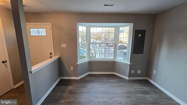 interior space with dark wood-type flooring and electric panel