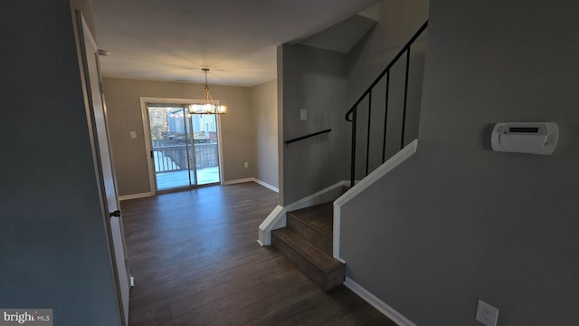 entryway with a chandelier and dark hardwood / wood-style flooring