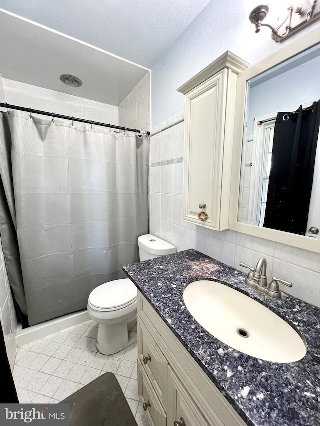 bathroom with vanity, a shower with curtain, backsplash, and tile patterned floors