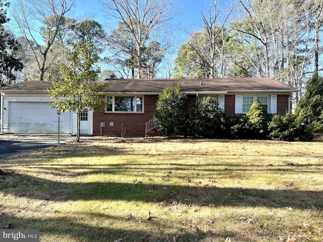 ranch-style home featuring a garage and a front lawn