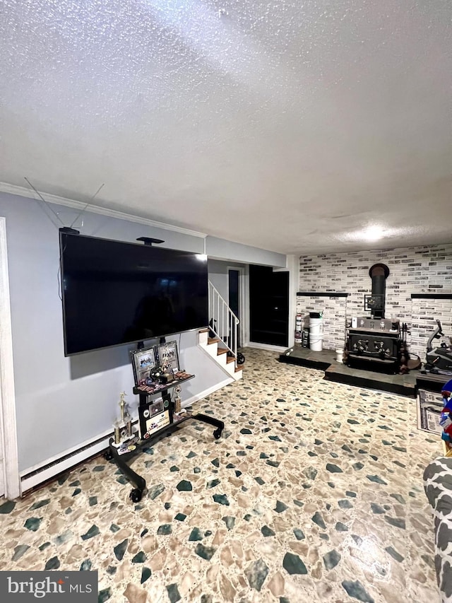 living room with a wood stove, crown molding, a textured ceiling, and a baseboard heating unit