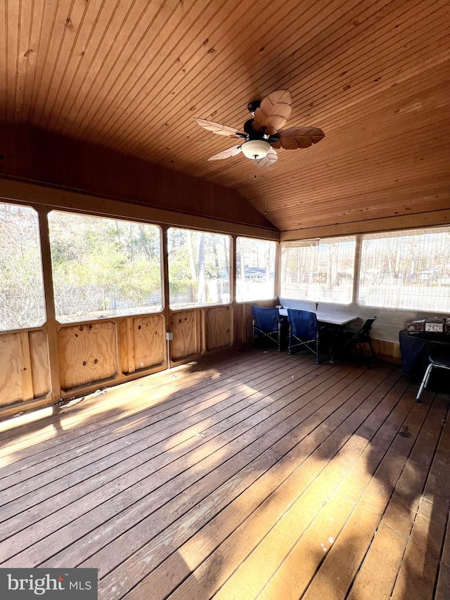 unfurnished sunroom with lofted ceiling, ceiling fan, and wooden ceiling