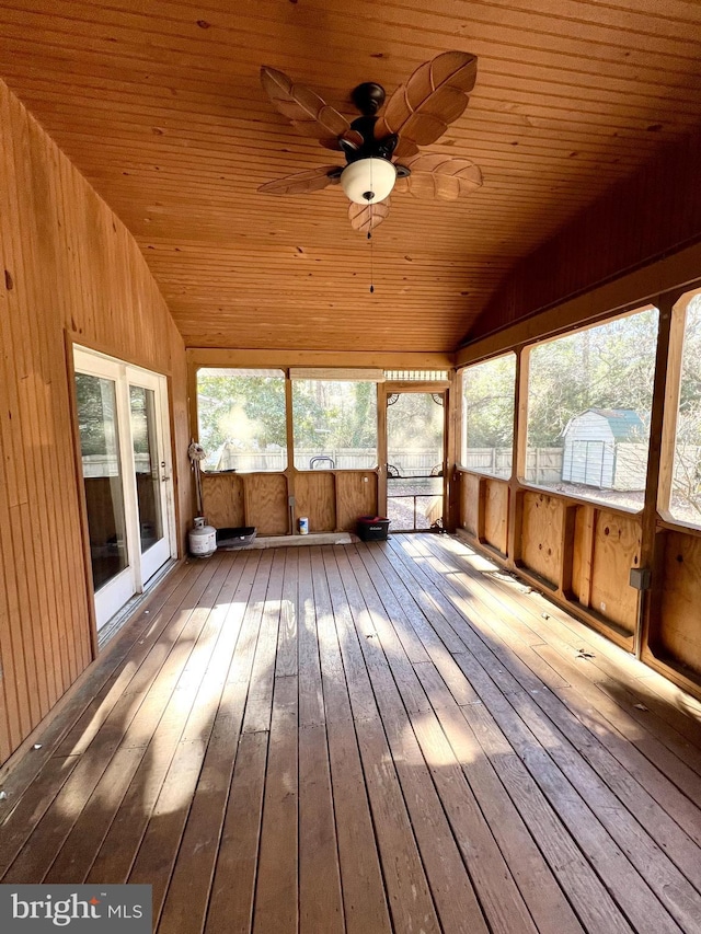 unfurnished sunroom with ceiling fan, wooden ceiling, and lofted ceiling