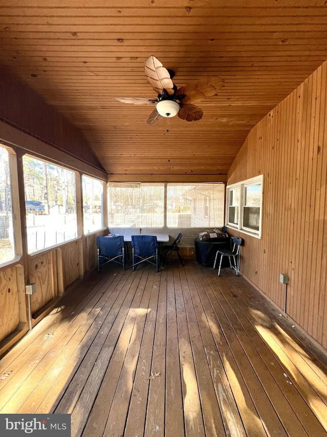 unfurnished sunroom featuring ceiling fan, lofted ceiling, and wooden ceiling